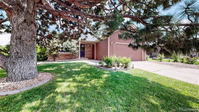 4396 Dearborn St, Denver, CO 80239 - view of grassy yard with concrete driveway and a garage