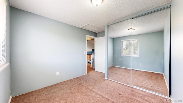 4396 Dearborn St, Denver, CO 80239 - unfurnished bedroom with carpet flooring, a closet, and a textured ceiling