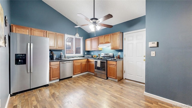 4396 Dearborn St, Denver, CO 80239 - kitchen featuring stainless steel appliances, ceiling fan, under cabinet range hood, light wood-style flooring, and dark countertops