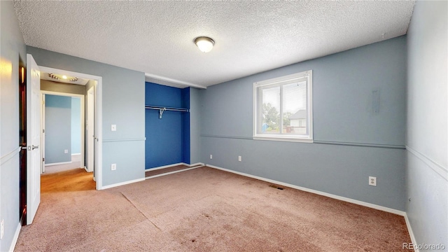 4396 Dearborn St, Denver, CO 80239 - unfurnished bedroom featuring carpet, a closet, and a textured ceiling