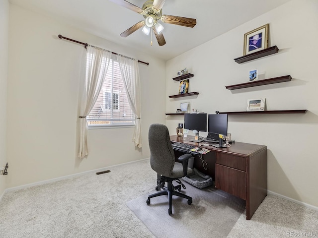 office space with light carpet and ceiling fan