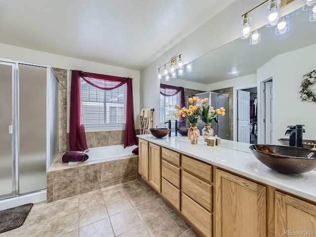 bathroom with independent shower and bath, vanity, and tile patterned floors