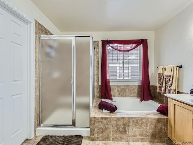 bathroom featuring vanity and separate shower and tub