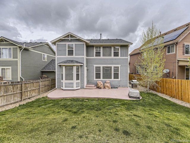 back of house with a patio area and a lawn