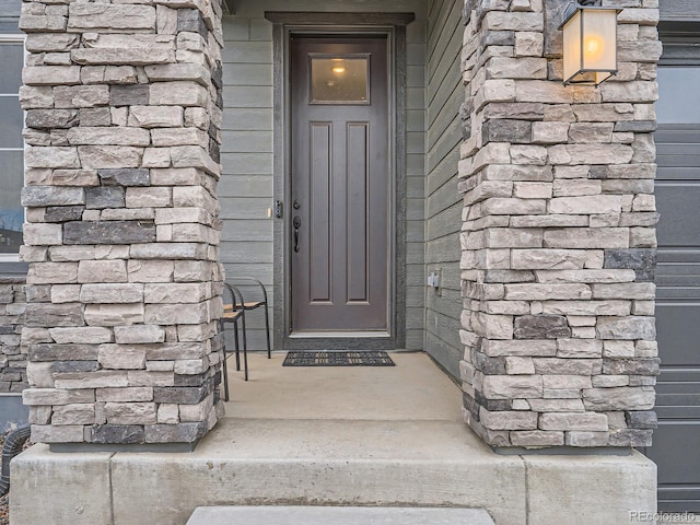 property entrance featuring stone siding