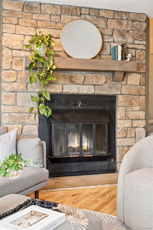 detailed view of a large fireplace and wood finished floors