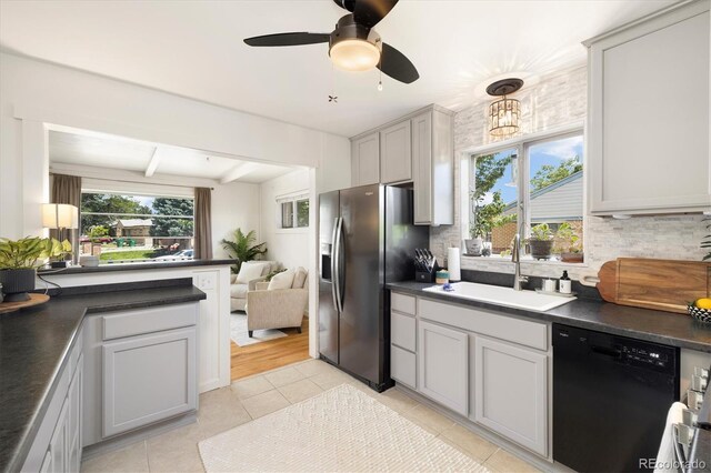 1760 W 74th Way, Denver, CO 80221 - kitchen with black dishwasher, stainless steel fridge with ice dispenser, dark countertops, tasteful backsplash, and light tile patterned floors