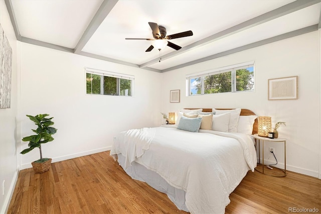 1760 W 74th Way, Denver, CO 80221 - bedroom with multiple windows, wood finished floors, and a ceiling fan