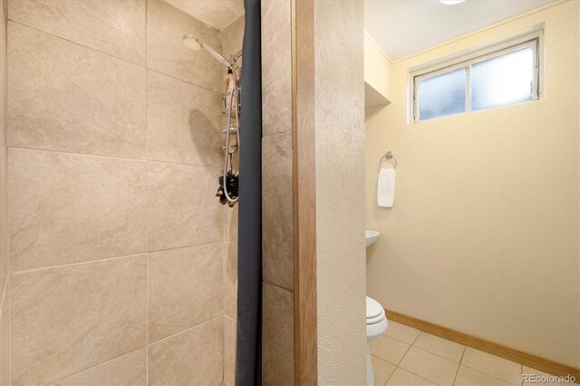 1760 W 74th Way, Denver, CO 80221 - bathroom with tiled shower and tile patterned flooring