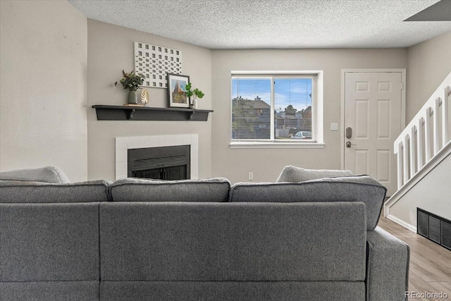 living room with hardwood / wood-style flooring and a textured ceiling