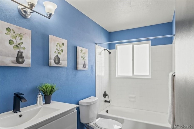 full bathroom with vanity, toilet, a textured ceiling, and tiled shower / bath