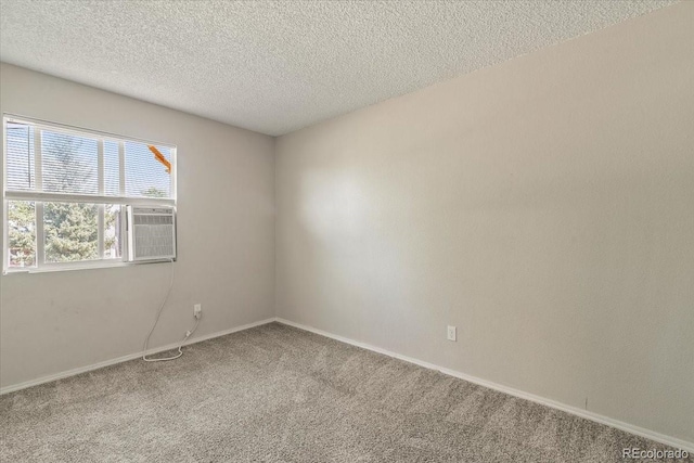 carpeted empty room with a textured ceiling