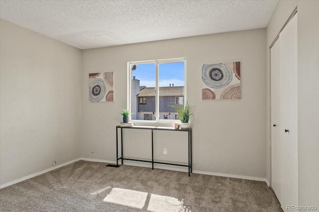 office area featuring light carpet and a textured ceiling