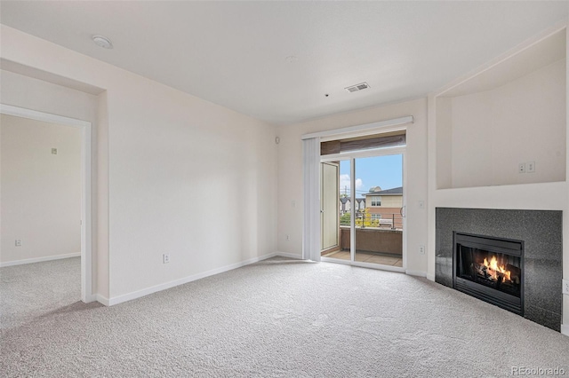 4100 Albion St Unit 617, Denver, CO 80216 - unfurnished living room with carpet floors, a lit fireplace, and baseboards