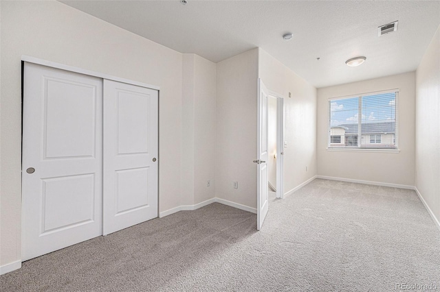 4100 Albion St Unit 617, Denver, CO 80216 - unfurnished bedroom with light colored carpet, baseboards, and a closet