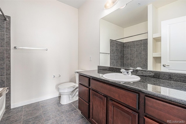 4100 Albion St Unit 617, Denver, CO 80216 - bathroom featuring a tile shower, vanity, toilet, baseboards, and tile patterned flooring