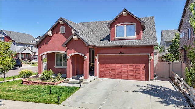 18009 E 47th Pl, Denver, CO 80249 - view of front of house with stucco siding, a shingled roof, concrete driveway, and an attached garage
