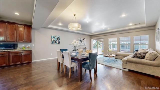 18009 E 47th Pl, Denver, CO 80249 - dining space featuring a tray ceiling, baseboards, dark wood-style flooring, and recessed lighting