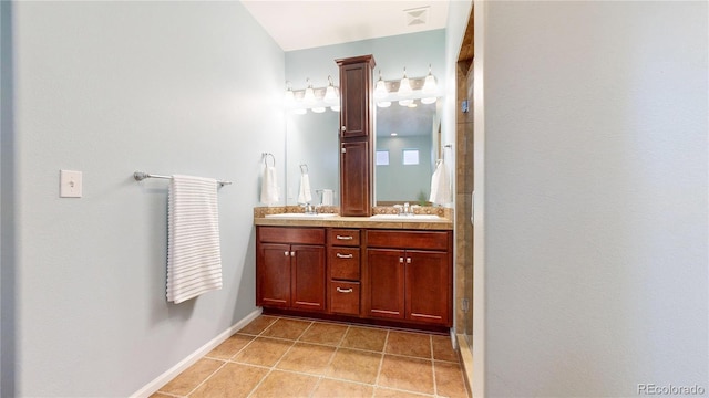 18009 E 47th Pl, Denver, CO 80249 - bathroom featuring double vanity, tile patterned floors, and baseboards