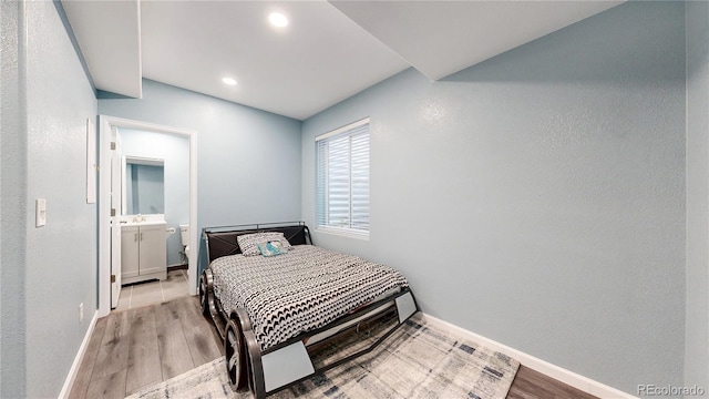 18009 E 47th Pl, Denver, CO 80249 - bedroom with wood finished floors, baseboards, recessed lighting, and ensuite bath