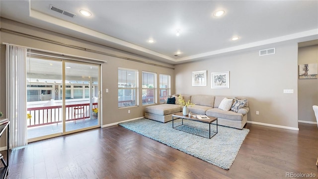 18009 E 47th Pl, Denver, CO 80249 - living room with baseboards, a tray ceiling, wood finished floors, and recessed lighting