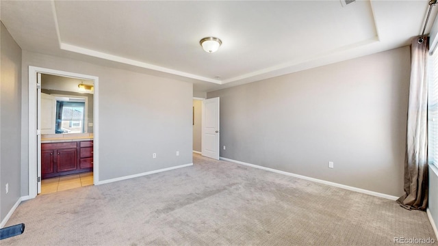 18009 E 47th Pl, Denver, CO 80249 - unfurnished bedroom featuring a raised ceiling, light carpet, and baseboards