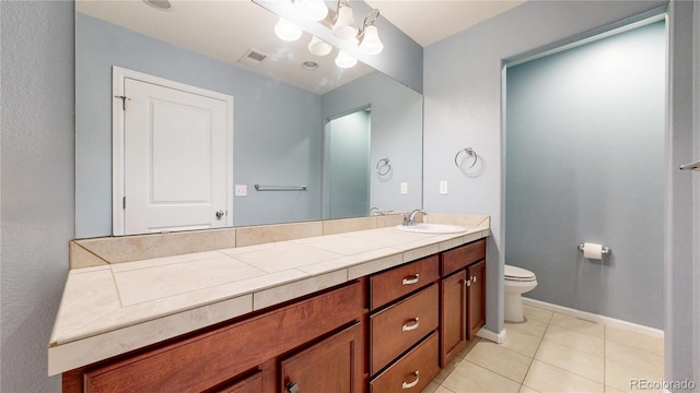 18009 E 47th Pl, Denver, CO 80249 - bathroom featuring vanity, tile patterned flooring, toilet, and baseboards