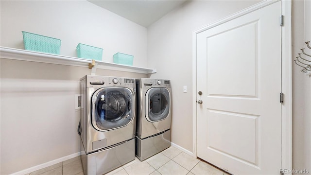18009 E 47th Pl, Denver, CO 80249 - laundry area featuring washer and clothes dryer, baseboards, and light tile patterned floors