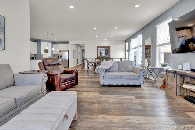 living area with recessed lighting and wood finished floors