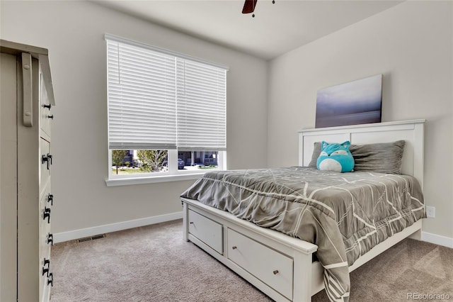 bedroom featuring carpet floors, baseboards, ceiling fan, and visible vents