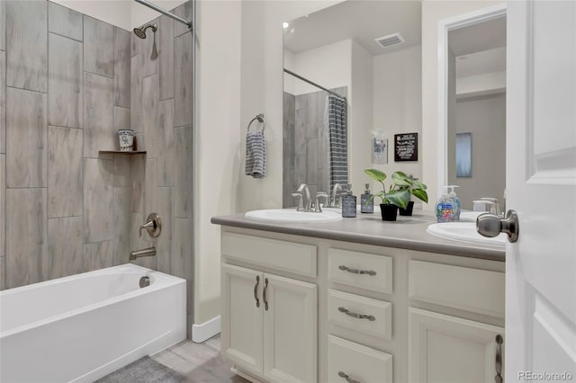 full bath featuring double vanity, visible vents, shower / bath combination with curtain, and a sink