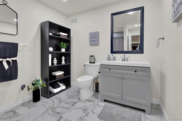bathroom featuring vanity, toilet, marble finish floor, baseboards, and visible vents