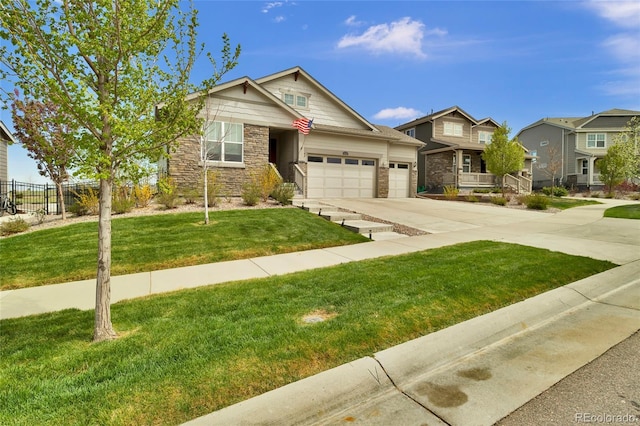 craftsman-style house featuring fence, a front lawn, stone siding, a garage, and concrete driveway