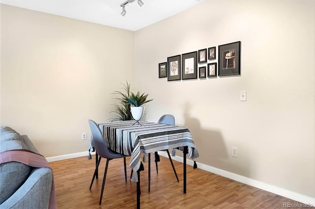 3050 W 32nd Ave Unit 202C, Denver, CO 80211 - dining space featuring baseboards, wood finished floors, and track lighting