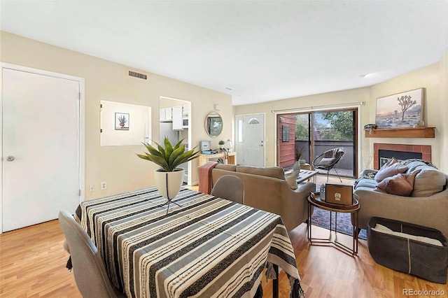 3050 W 32nd Ave Unit 202C, Denver, CO 80211 - living room featuring light wood-style floors and a fireplace