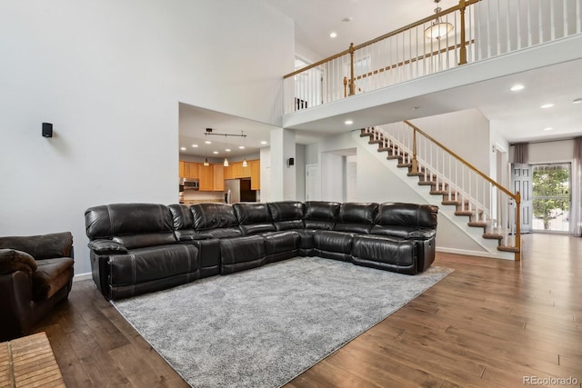 19653 E Ida Dr, Aurora, CO 80015 - living area with a high ceiling, stairs, wood finished floors, and recessed lighting