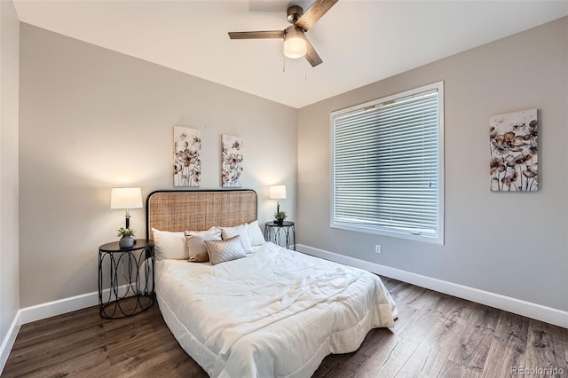 bedroom with dark hardwood / wood-style floors and ceiling fan