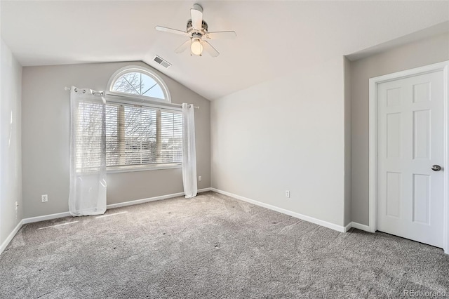 spare room featuring lofted ceiling, ceiling fan, and carpet flooring