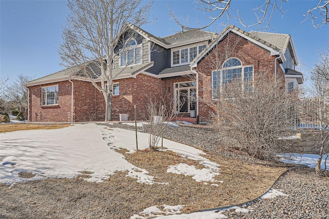 view of front facade featuring driveway and brick siding