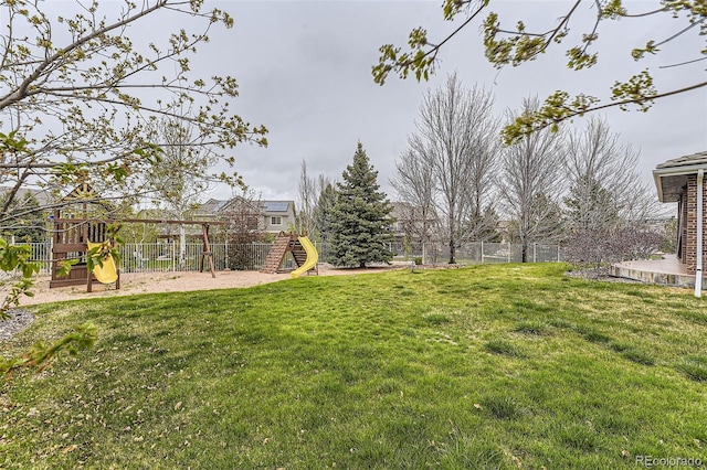 view of yard featuring a playground and fence