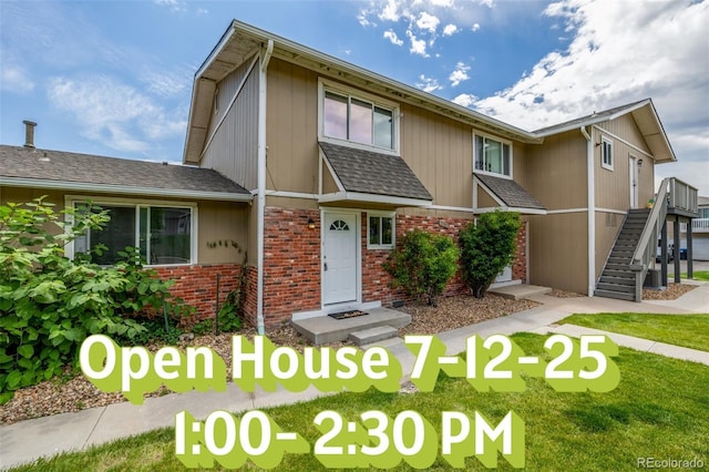 2232 Coronado Pkwy Unit B, Denver, CO 80229 - view of front of house featuring brick siding, stairway, and a shingled roof