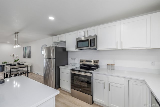 2232 Coronado Pkwy Unit B, Denver, CO 80229 - kitchen featuring appliances with stainless steel finishes, white cabinets, light countertops, and recessed lighting