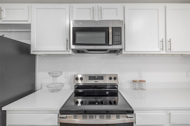 2232 Coronado Pkwy Unit B, Denver, CO 80229 - kitchen with appliances with stainless steel finishes, light countertops, and white cabinetry