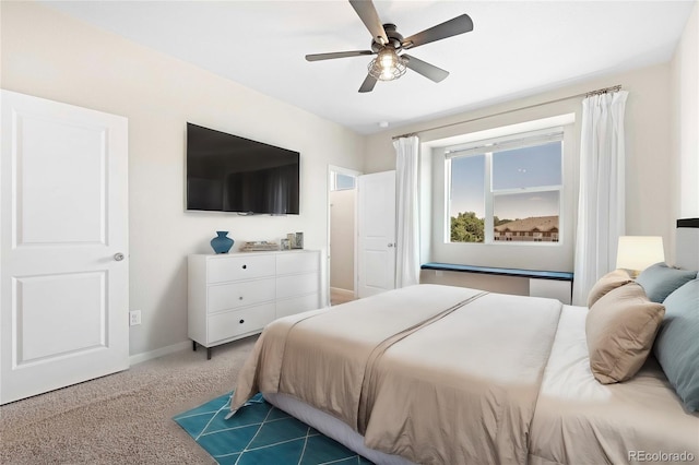 bedroom featuring dark carpet and ceiling fan