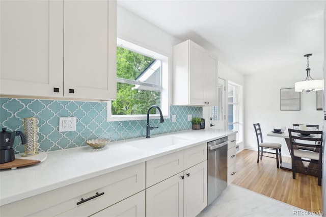 5445 Nebraska Way, Denver, CO 80246 - kitchen with a sink, dishwasher, decorative backsplash, white cabinetry, and light countertops