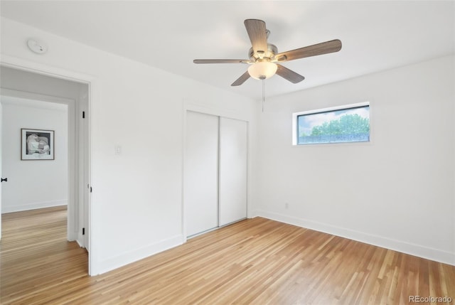 5445 Nebraska Way, Denver, CO 80246 - unfurnished bedroom featuring a closet, light wood finished floors, baseboards, and a ceiling fan