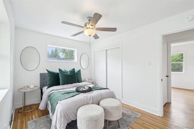 5445 Nebraska Way, Denver, CO 80246 - bedroom with a closet, light wood finished floors, ceiling fan, and baseboards