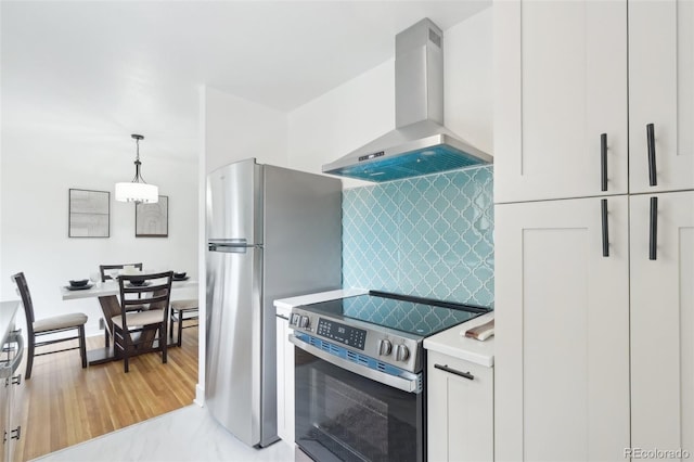 5445 Nebraska Way, Denver, CO 80246 - kitchen featuring stainless steel appliances, extractor fan, light countertops, decorative light fixtures, and decorative backsplash