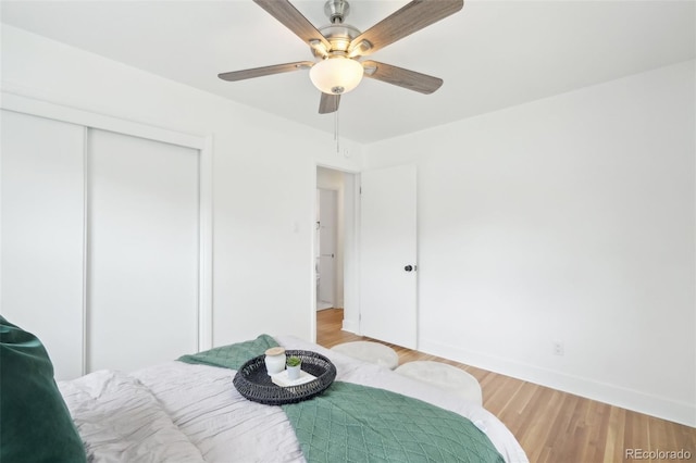 5445 Nebraska Way, Denver, CO 80246 - bedroom with a closet, light wood-style floors, baseboards, and ceiling fan