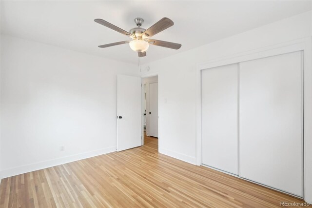 5445 Nebraska Way, Denver, CO 80246 - unfurnished bedroom featuring a closet, light wood-style flooring, baseboards, and a ceiling fan